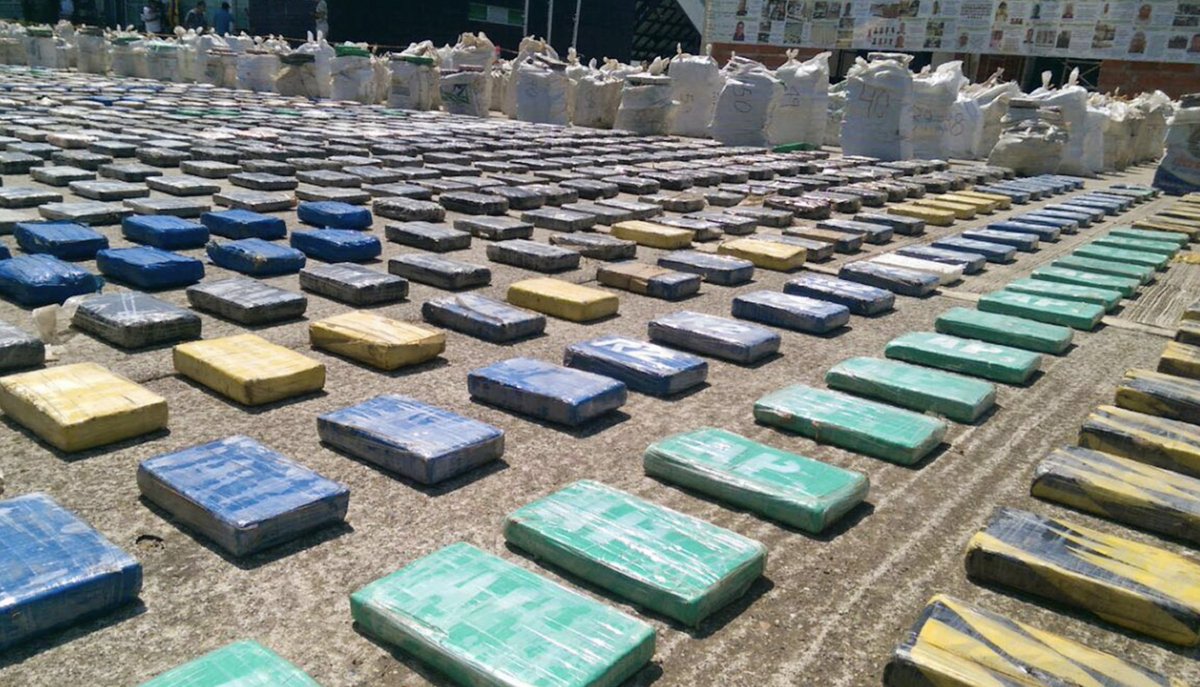 Rows of seized cocaine packages arranged on a ship deck
